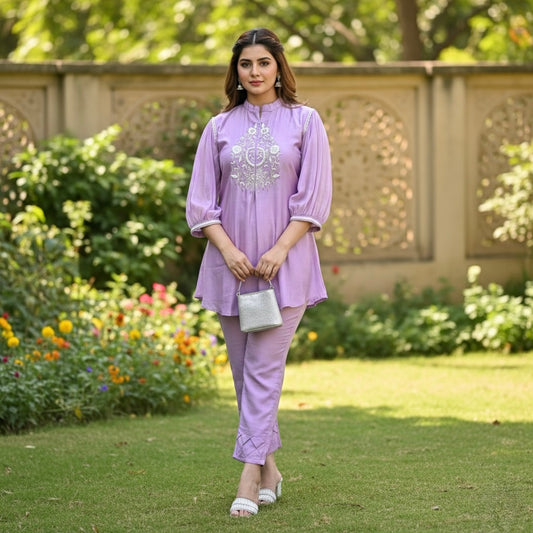 Woman in a lLavender Meadows Embroidered Cotton Coord Set standing in a garden. festive cotton coord set