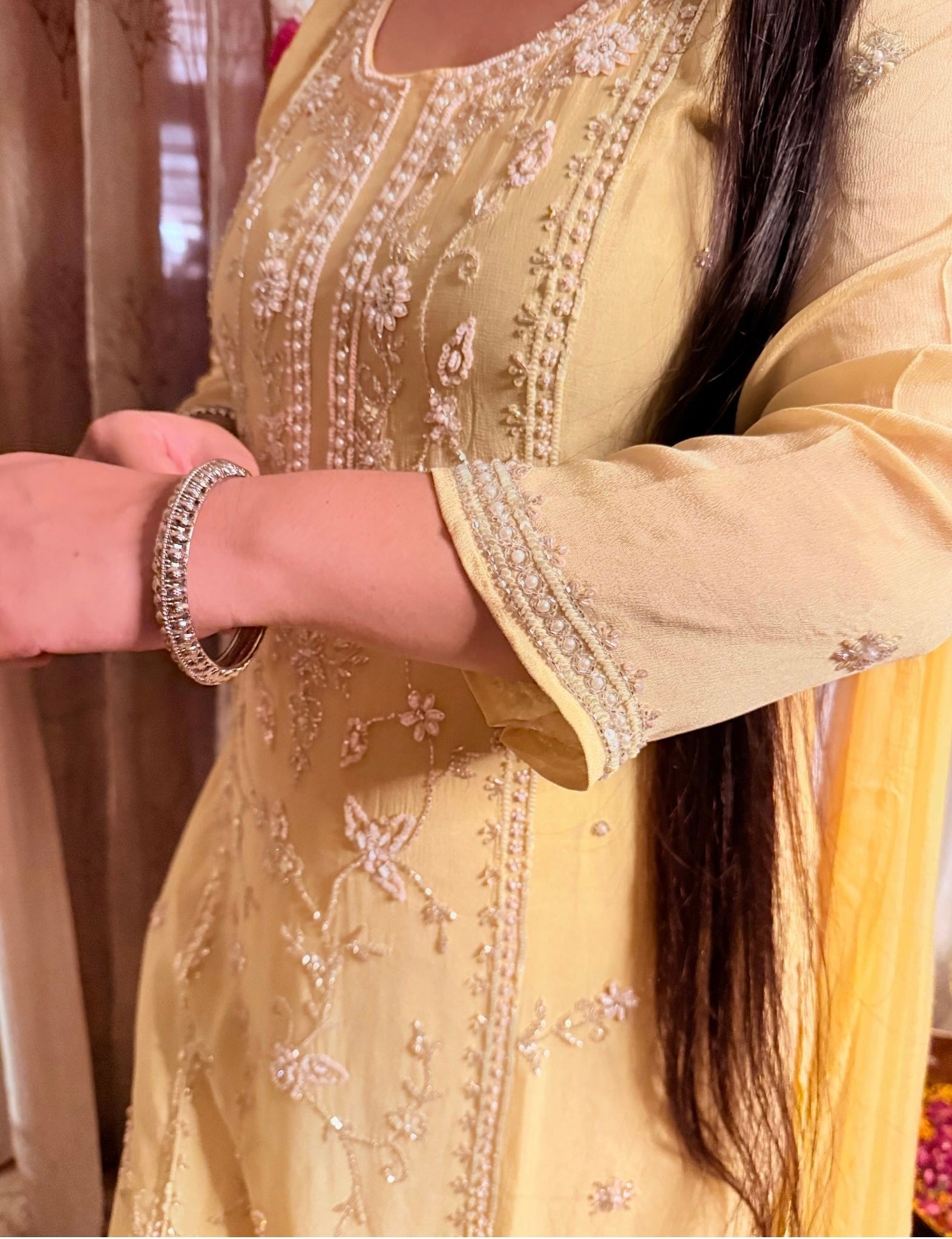 Beige embroidered traditional outfit with a person wearing it, focusing on the intricate details. Lemonlight_Embroidered_Chinon_Suit